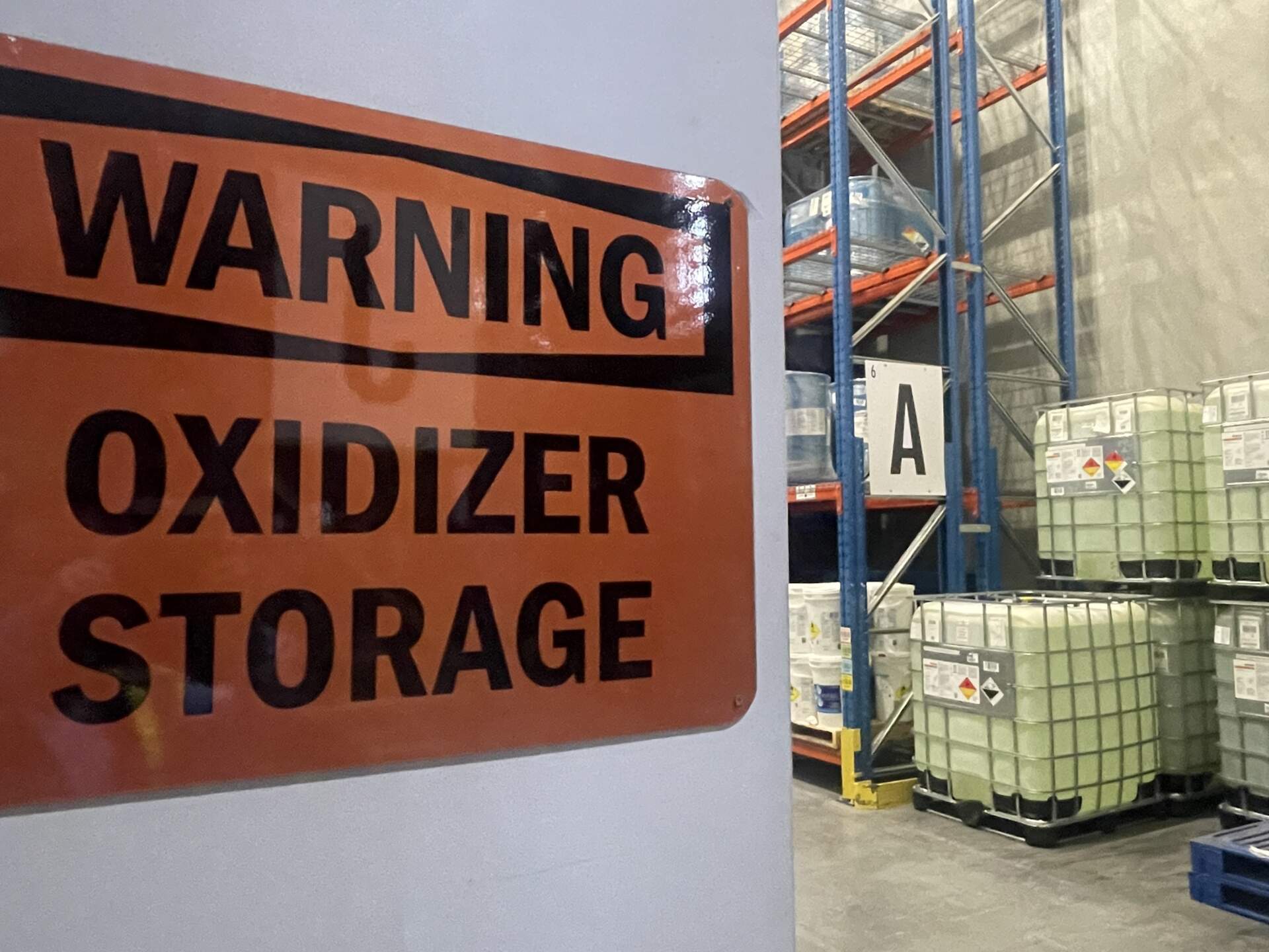 A hazardous materials sign reads: warning, oxidizer storage.