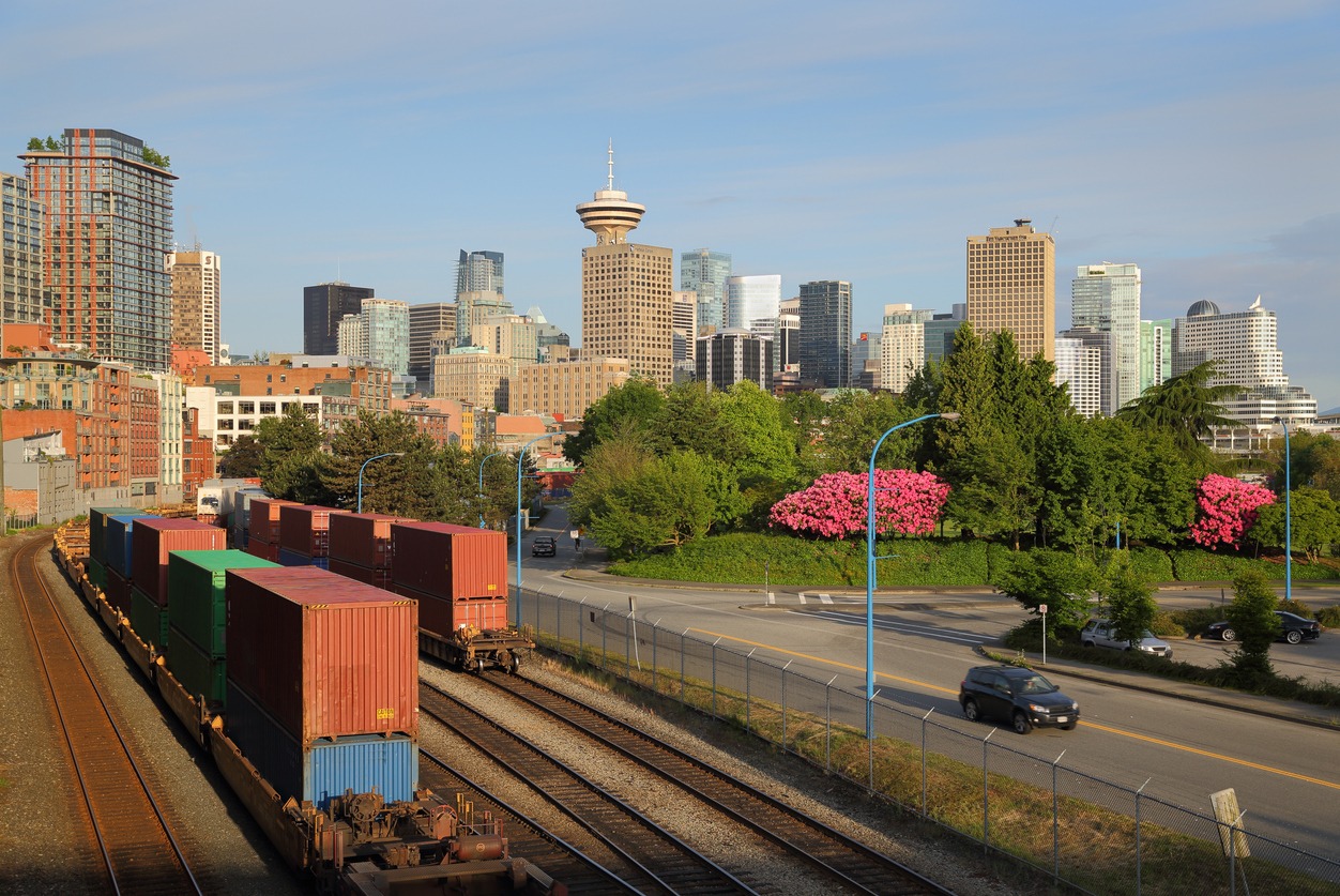 A railway with the Vancouver skyline in the background. Example of freight forwarding services.