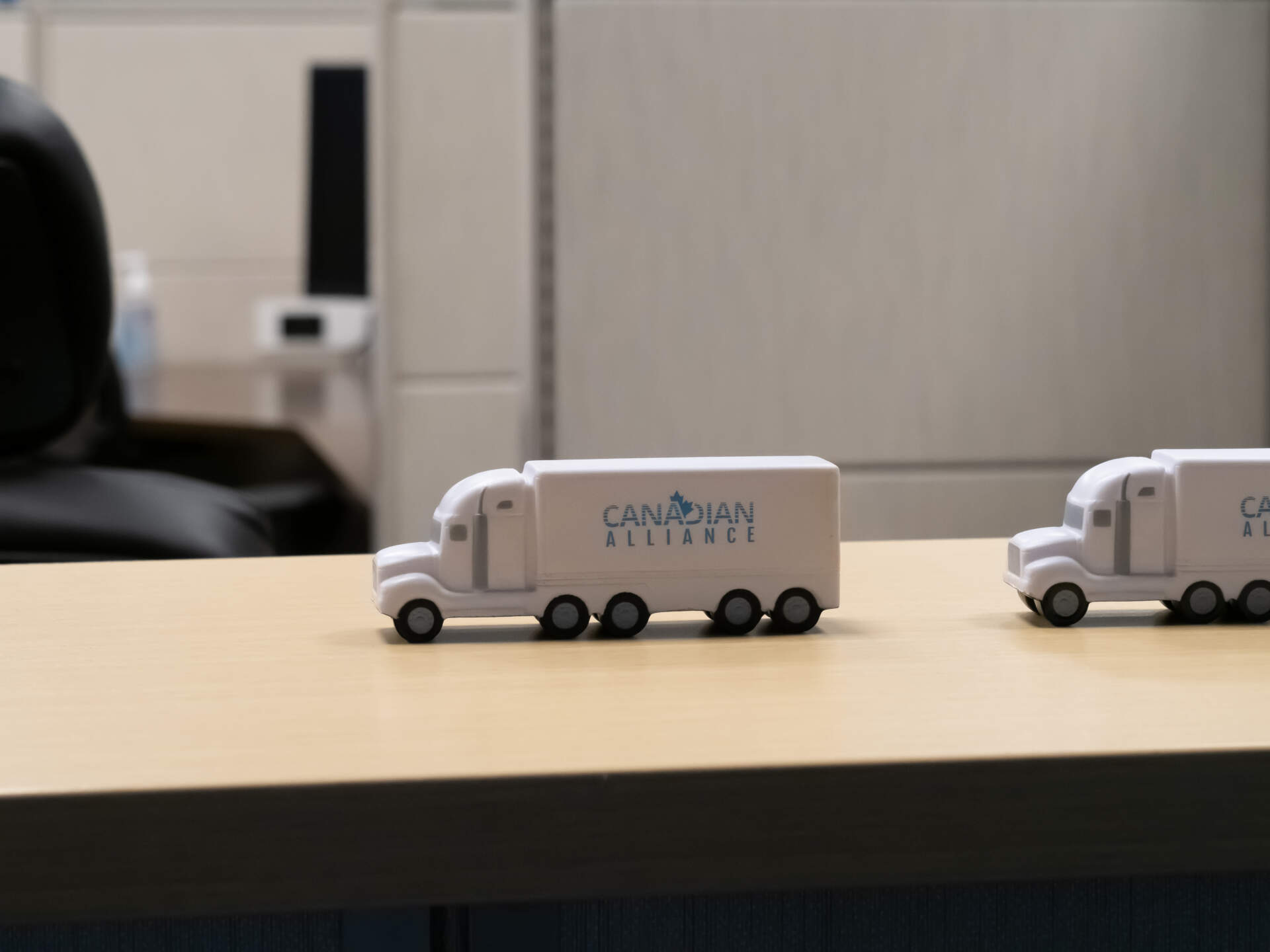 A Canadian Alliance model truck on a desk illustrates a freight brokerage