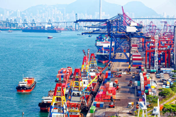 An image of the Port of Vancouver demonstrates international trade.
