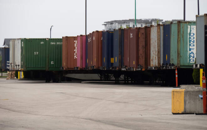 Sea containers are lined up, demonstrating international trade.