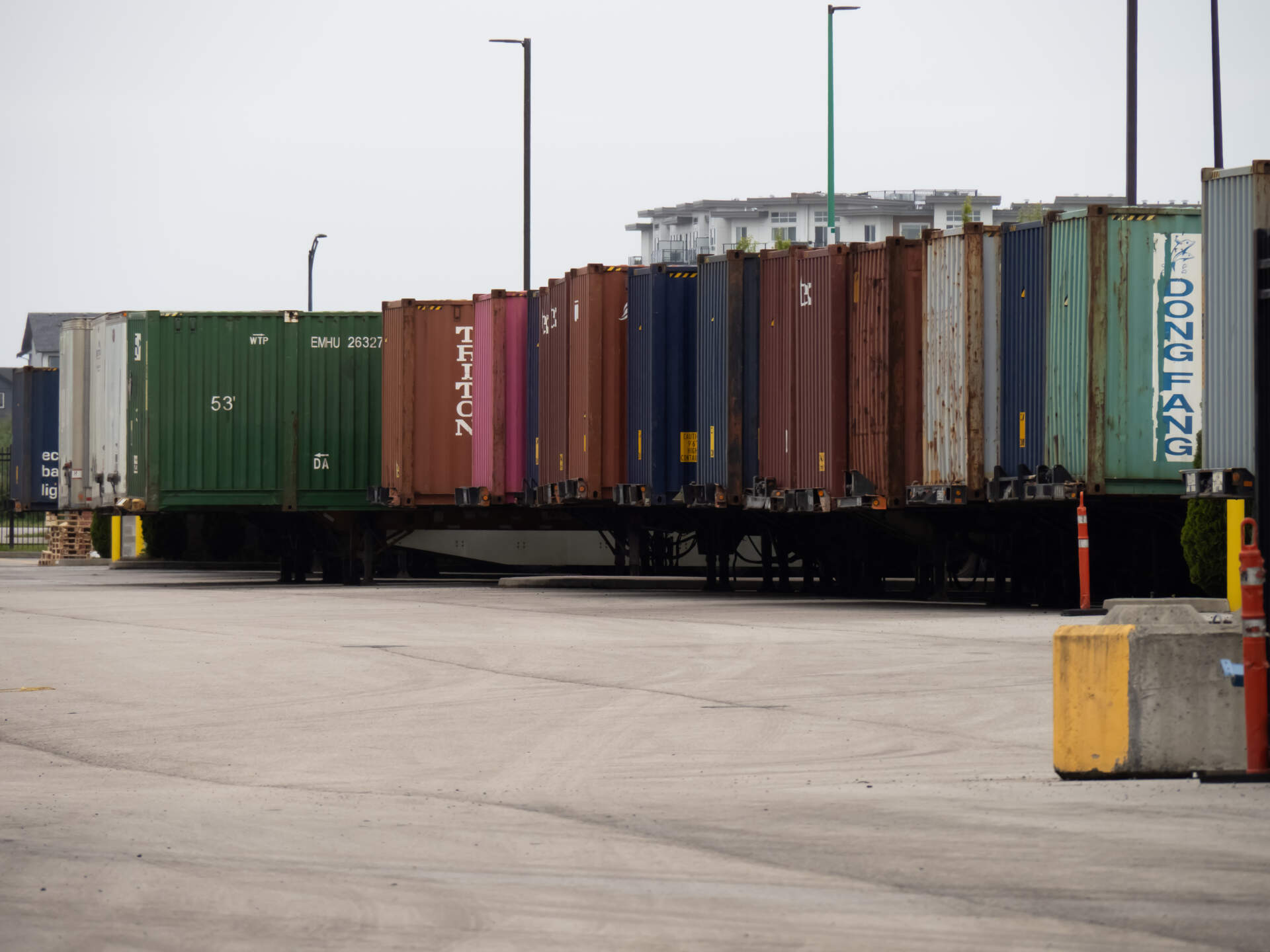 Sea containers are lined up, demonstrating international trade.